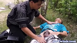 Asian doctor blows twink outdoor as first aid
